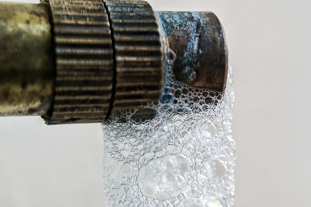 Professional plumber performing a hydro jetting service to clear tough pipe blockages