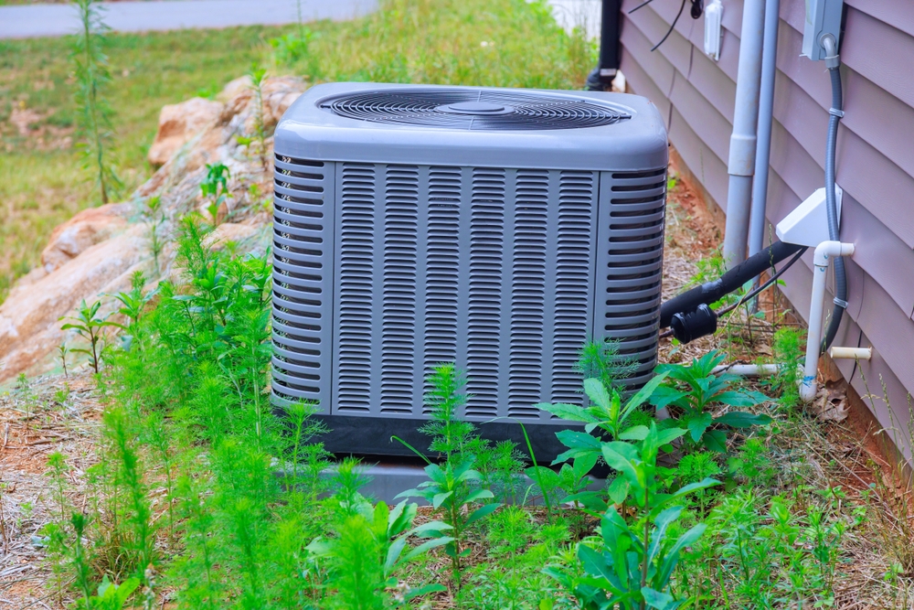 HVAC technician explaining AC service cost during an air conditioning inspection